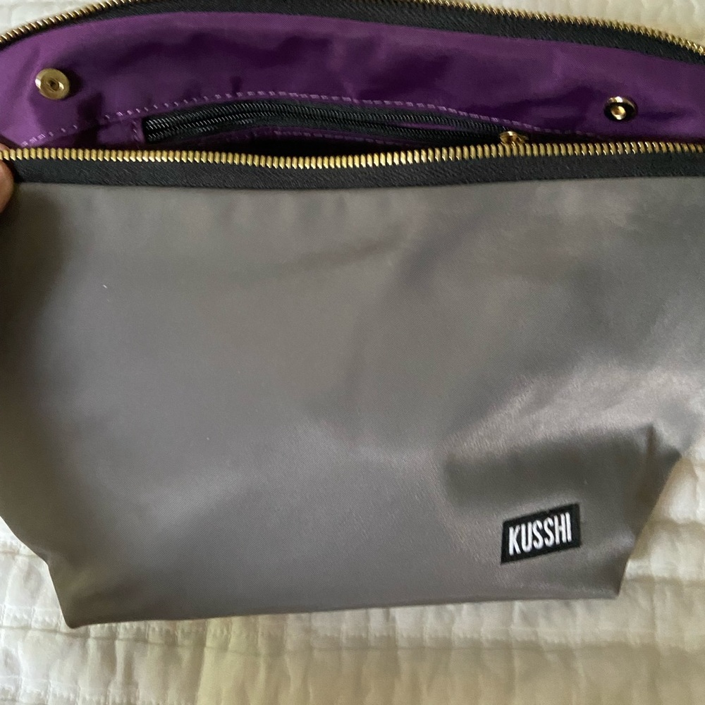Kusshi Signature bag grey with purple interior, and including an organizer.